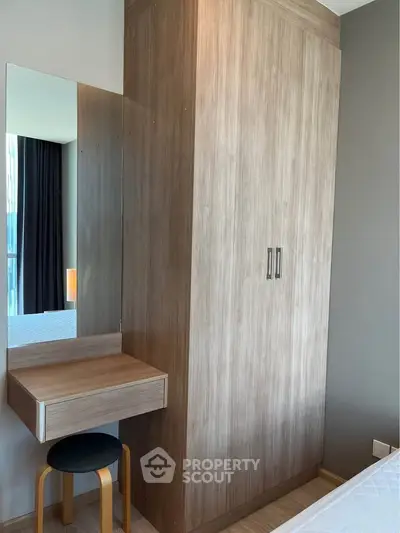 Modern bedroom with sleek wooden wardrobe and compact dressing table