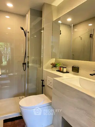 Modern bathroom with sleek fixtures and glass shower enclosure