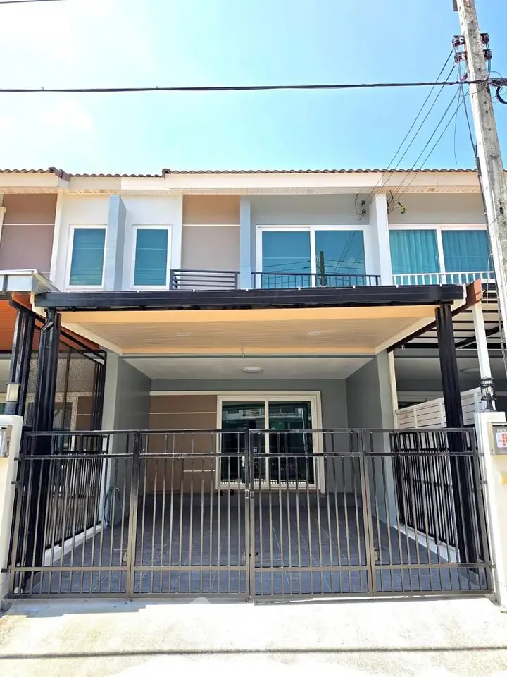 Modern townhouse exterior with gated parking and contemporary design