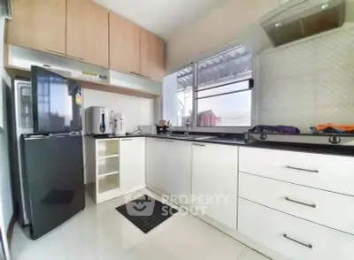 Modern kitchen with sleek cabinets and stainless steel appliances in a bright, airy space.