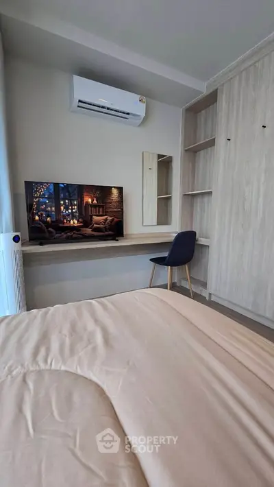Cozy bedroom with built-in wardrobe and modern TV setup
