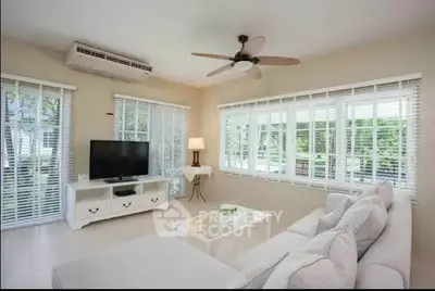 Bright and airy living room with modern decor and large windows.