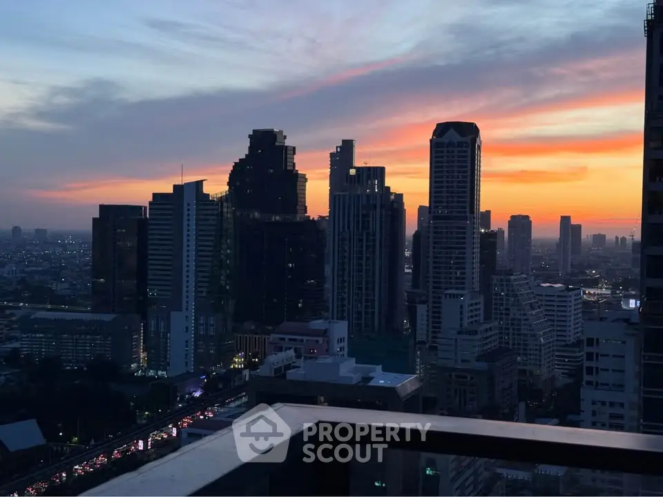 Stunning city skyline view from a high-rise balcony at sunset, perfect for urban living enthusiasts.
