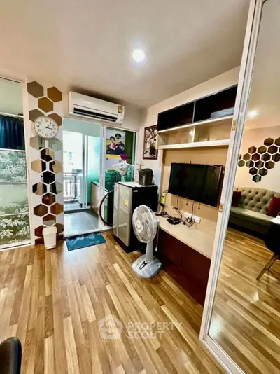 Modern living room with wooden flooring, air conditioning, and balcony access in a stylish apartment.