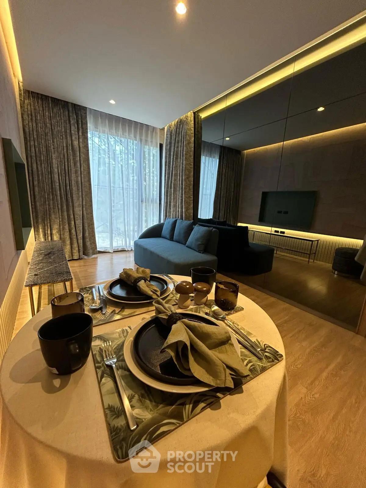 Modern living room with elegant dining setup and cozy seating area.