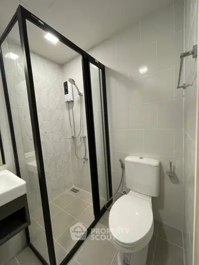 Modern bathroom with glass shower enclosure and sleek fixtures