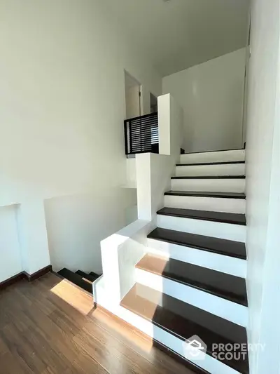 Modern staircase with sleek design and natural light in contemporary home