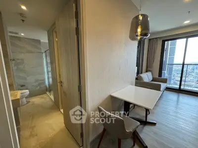 Modern apartment interior with open living area and city view balcony.