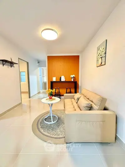 Modern living room with beige sofa and stylish decor in a bright apartment.