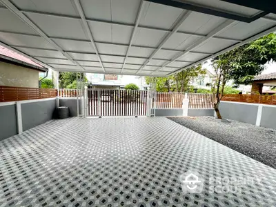 Spacious covered parking area with modern design and secure gate