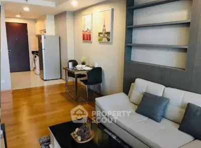 Modern living room with stylish decor and open kitchen layout in a cozy apartment.