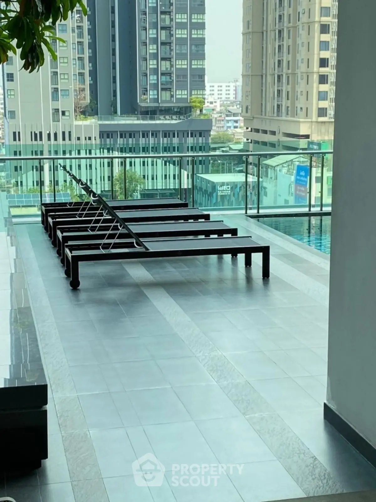 Luxurious rooftop pool area with modern sun loungers and stunning city views.