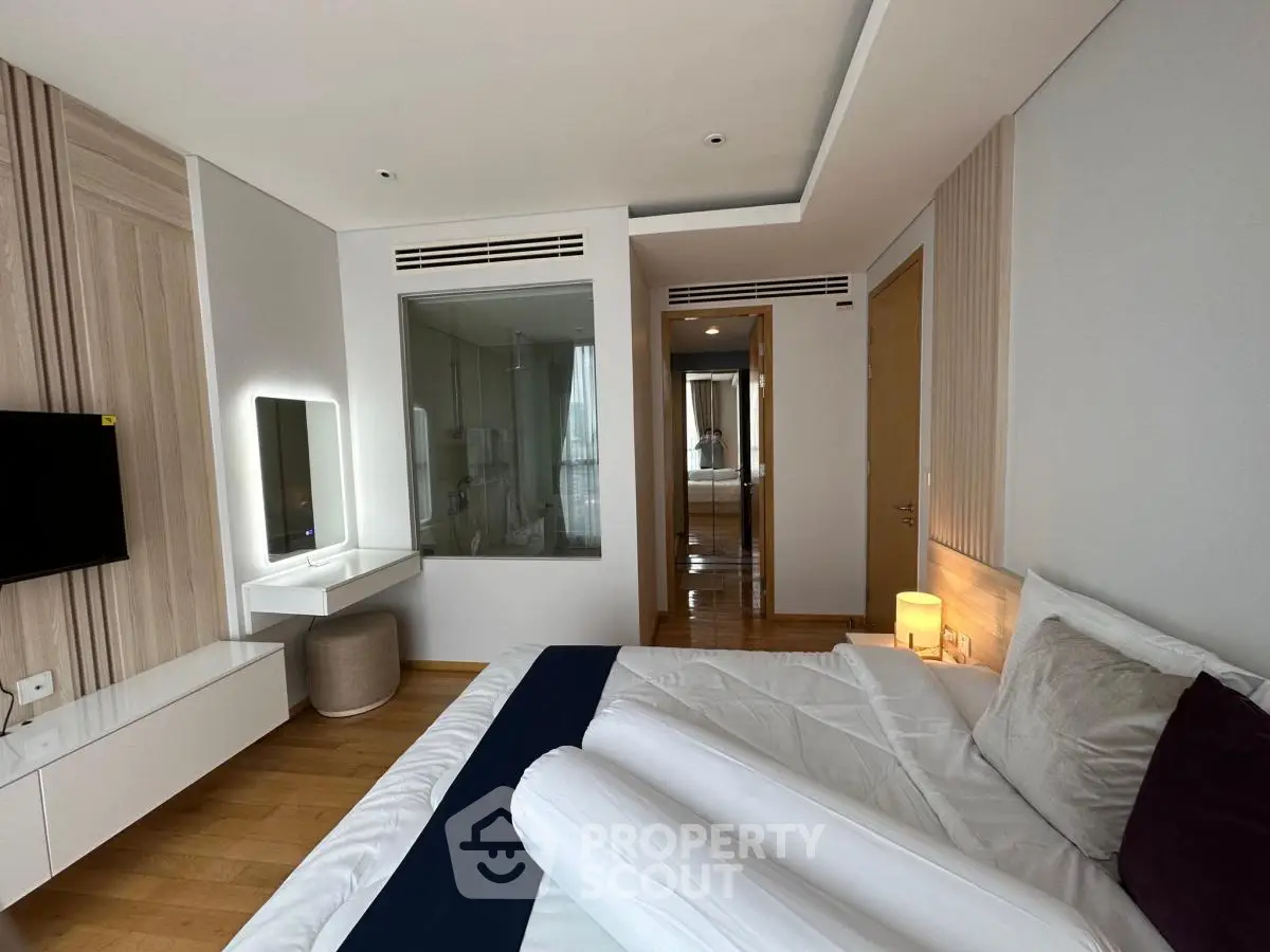 Luxurious modern bedroom with elegant decor and ambient lighting, featuring a cozy bed and stylish furnishings.