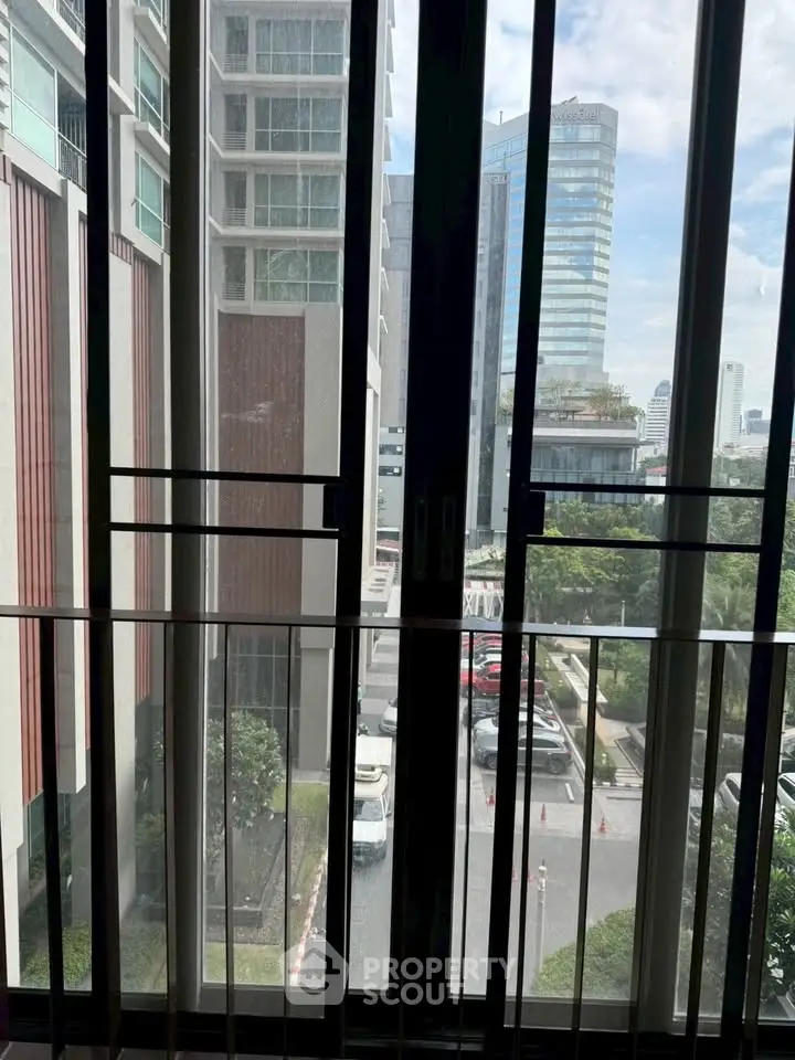 Stunning urban view from a high-rise apartment window showcasing modern cityscape.