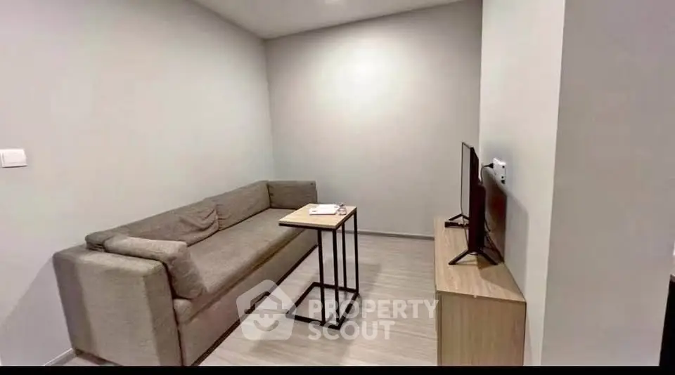 Modern living room with sleek sofa and TV setup, perfect for cozy relaxation.