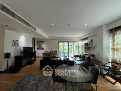 Spacious modern living room with large windows and stylish decor, perfect for relaxation and entertainment.