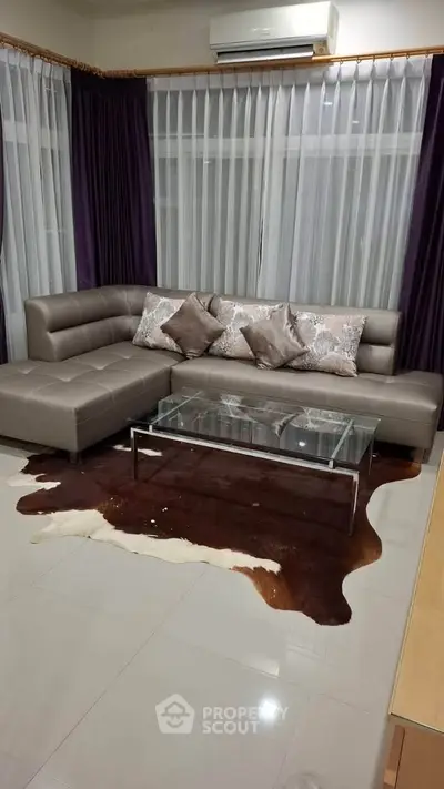 Stylish living room with modern sectional sofa and glass coffee table