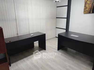 Modern office space with two sleek desks and minimalist decor