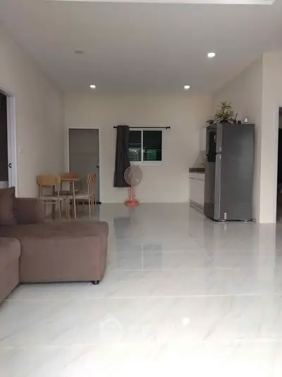 Spacious open-plan living room with modern kitchen and dining area