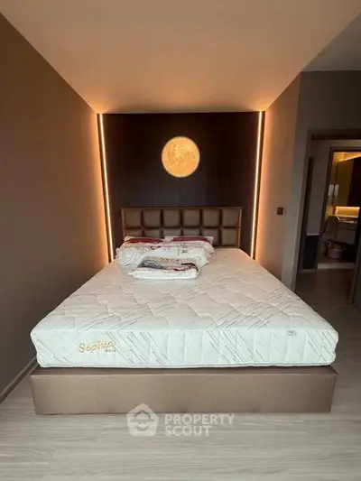 Modern bedroom with stylish lighting and comfortable bed in luxury apartment.