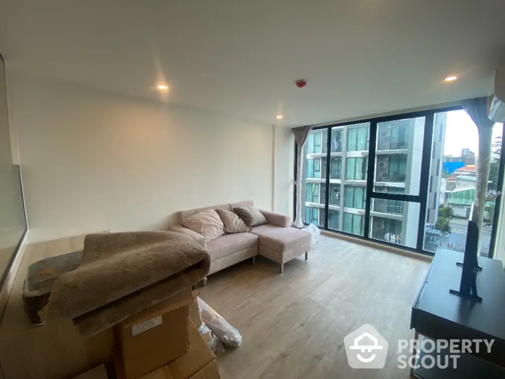 Modern living room with large windows and city view in a stylish apartment