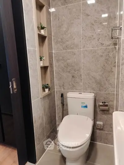 Modern bathroom with sleek toilet and elegant tile design