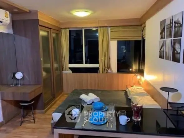 Cozy bedroom with modern decor and dining setup, perfect for urban living.