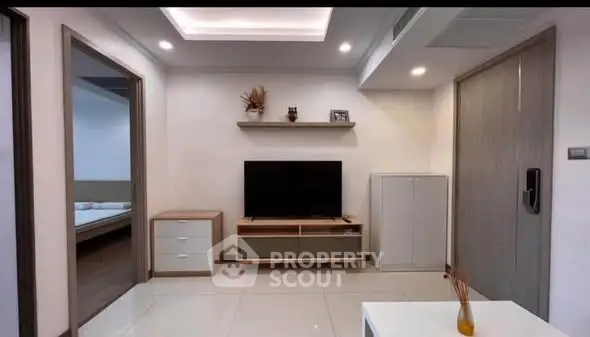 Modern living room with sleek furniture and wall-mounted TV