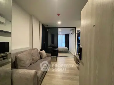 Modern apartment interior with cozy living room and bedroom view, featuring stylish decor and ample natural light.