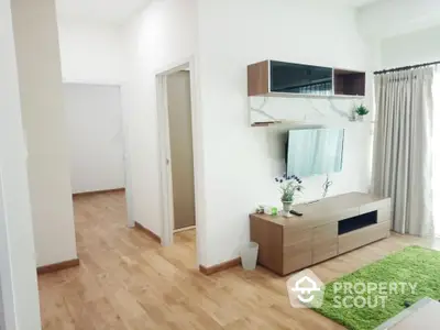 Modern living room with wooden flooring and stylish TV unit