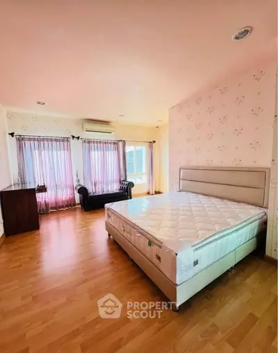 Spacious bedroom with elegant decor and natural light