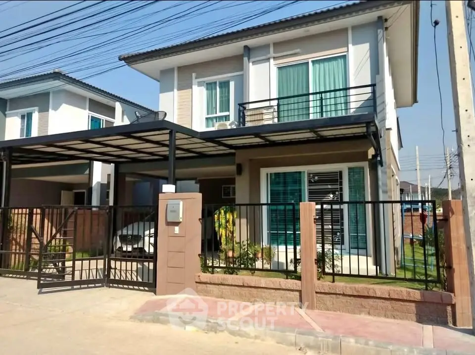 Modern two-story house with gated driveway and carport in a suburban neighborhood.
