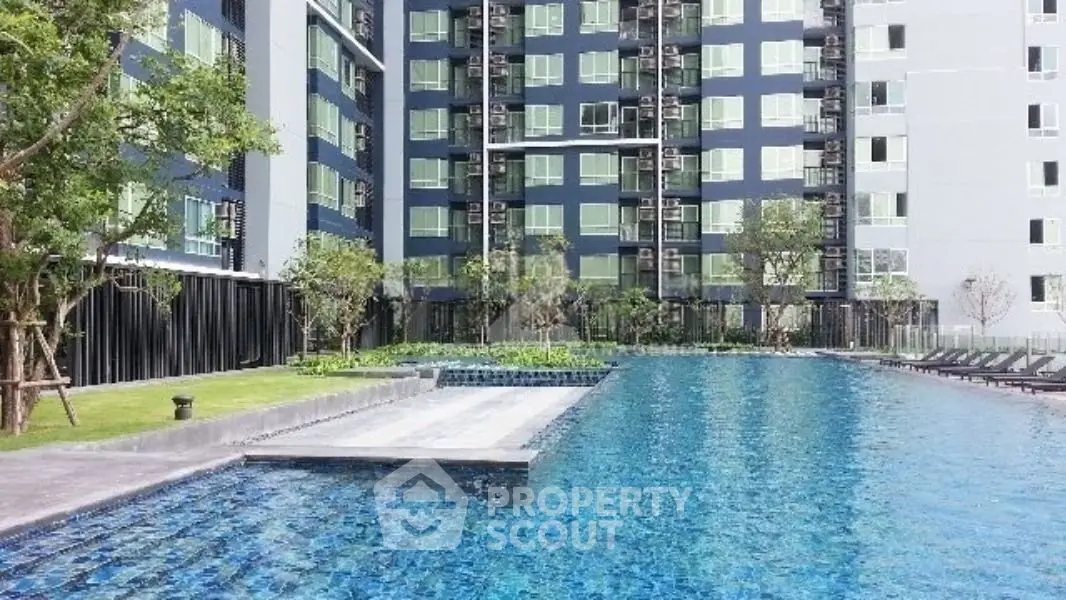 Luxurious apartment complex with stunning pool and modern architecture.