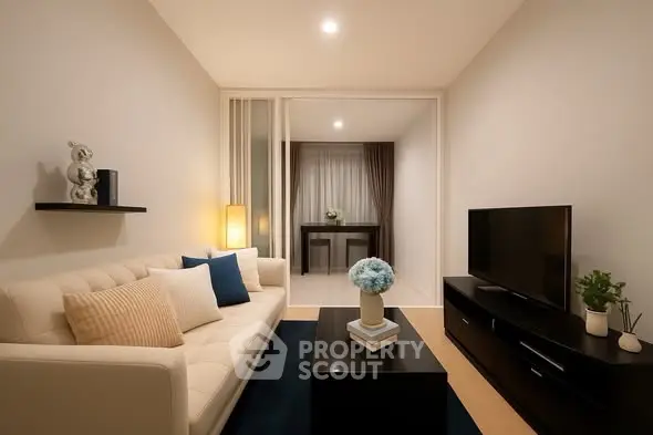 Modern living room with cozy sofa and sleek TV unit, perfect for relaxation.