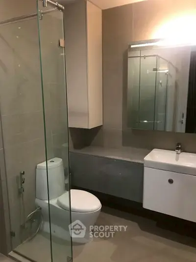 Modern bathroom with glass shower and sleek fixtures