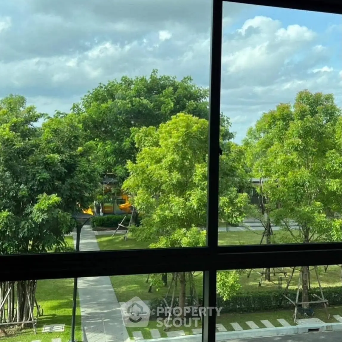 Scenic view of lush green garden from a window, perfect for nature lovers.