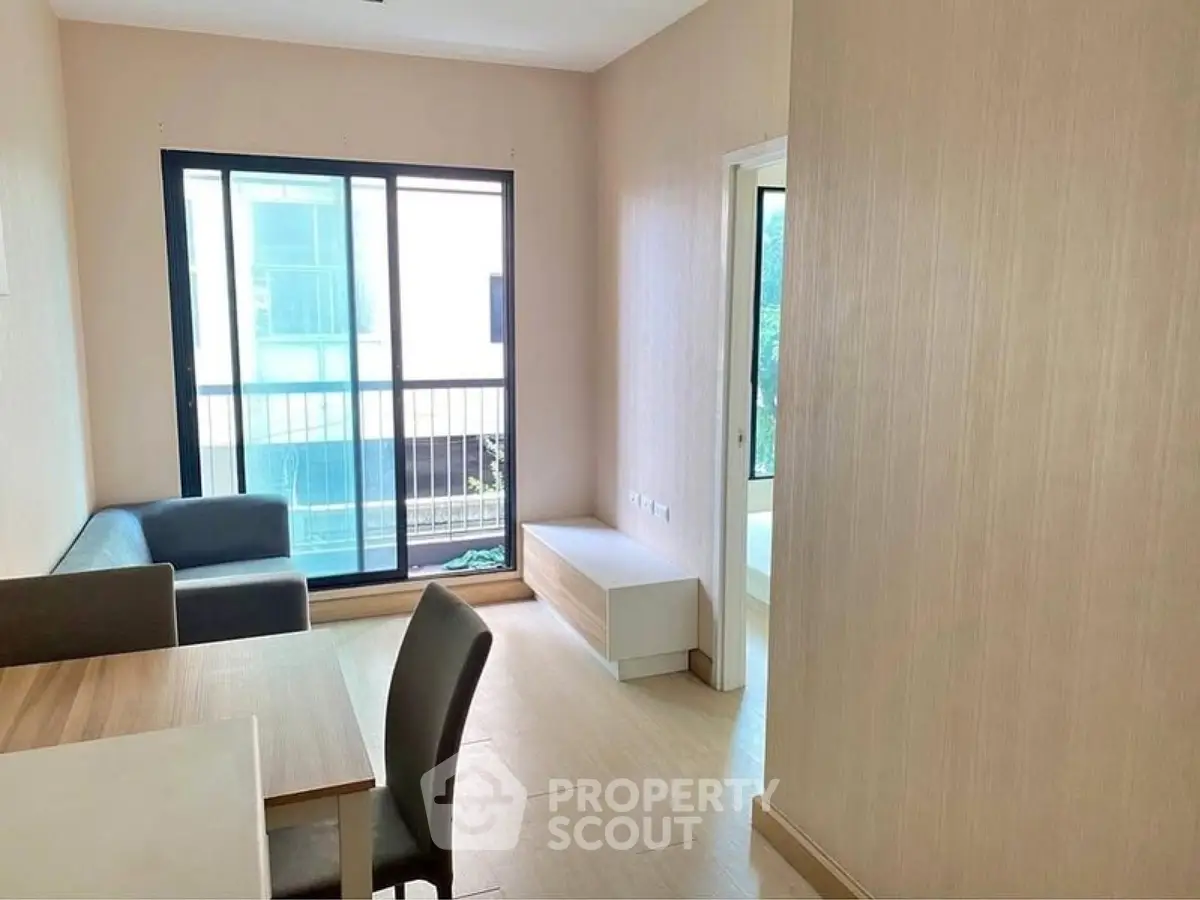 Bright living room with modern furniture and large window in a stylish apartment.