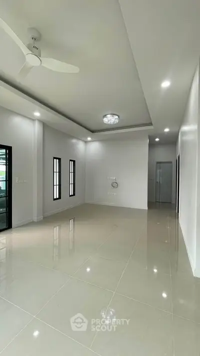 Spacious modern living room with high ceilings and elegant lighting