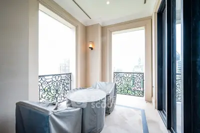 Luxurious balcony with elegant ironwork and city view, perfect for relaxation.