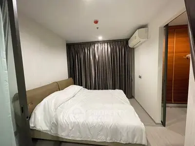 Cozy modern bedroom with elegant curtains and air conditioning