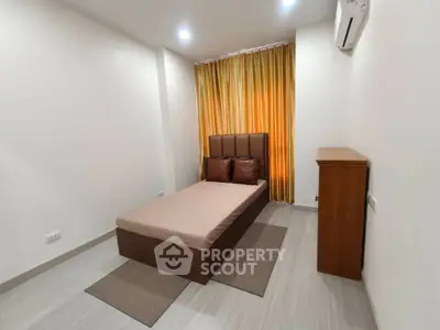 Cozy minimalist bedroom with modern furnishings and warm lighting