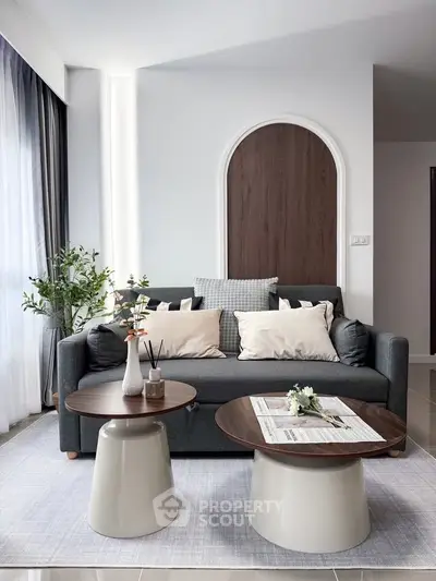 Stylish living room with modern sofa and chic coffee tables, perfect for relaxation and entertaining.