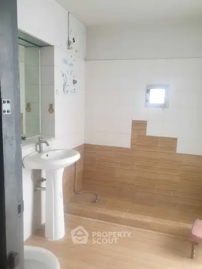 Spacious bathroom with modern sink and tiled walls, ideal for a contemporary home.