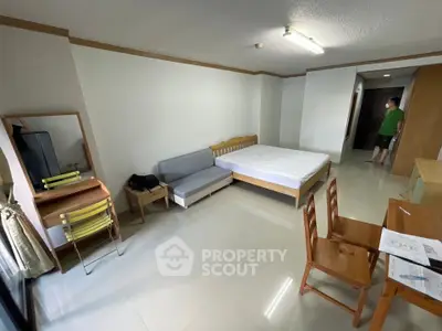 Spacious studio apartment with modern furnishings and ample natural light.