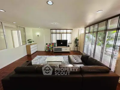 Spacious living room with modern decor and large windows for natural light