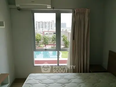 Modern bedroom with pool view, large window, and air conditioning unit.