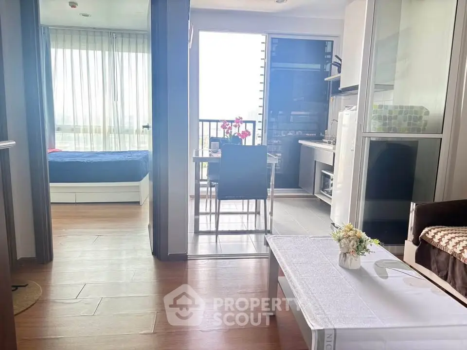 Modern apartment interior with open layout, featuring a cozy living area and dining space with natural light.