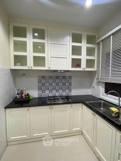 Charming kitchen with modern cabinetry and sleek black countertops