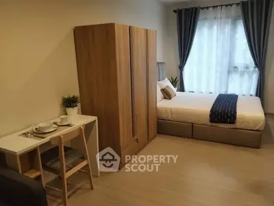 Cozy bedroom with modern furniture and natural light, perfect for relaxation.