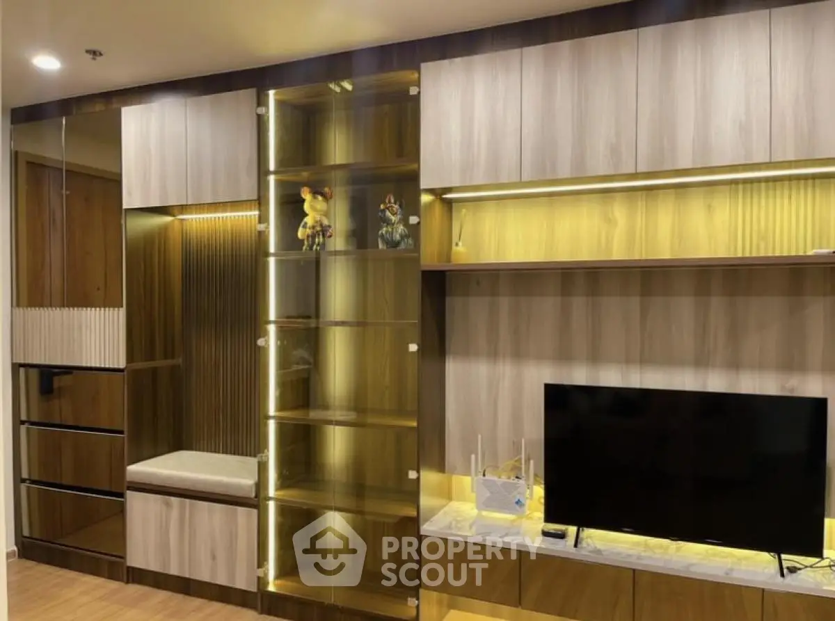 Modern living room with stylish wooden cabinetry and sleek TV setup